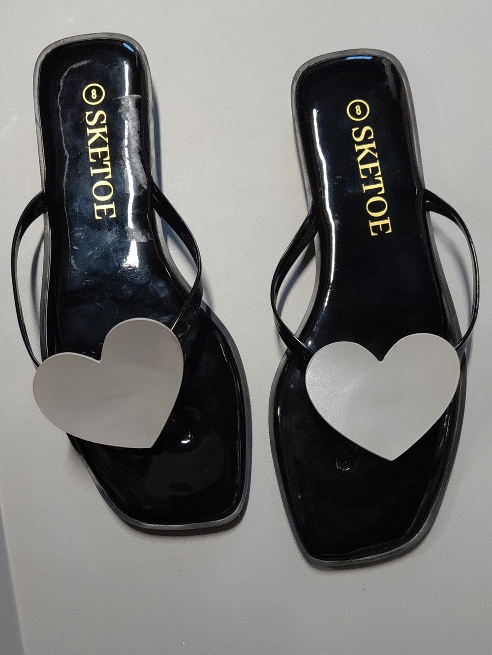 SKETOE Women's Black Jelly Flip Flops with White Heart Accent